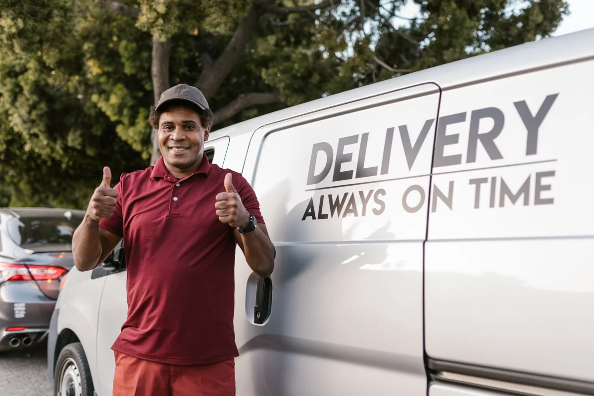 Smiling courier giving a thumbs up